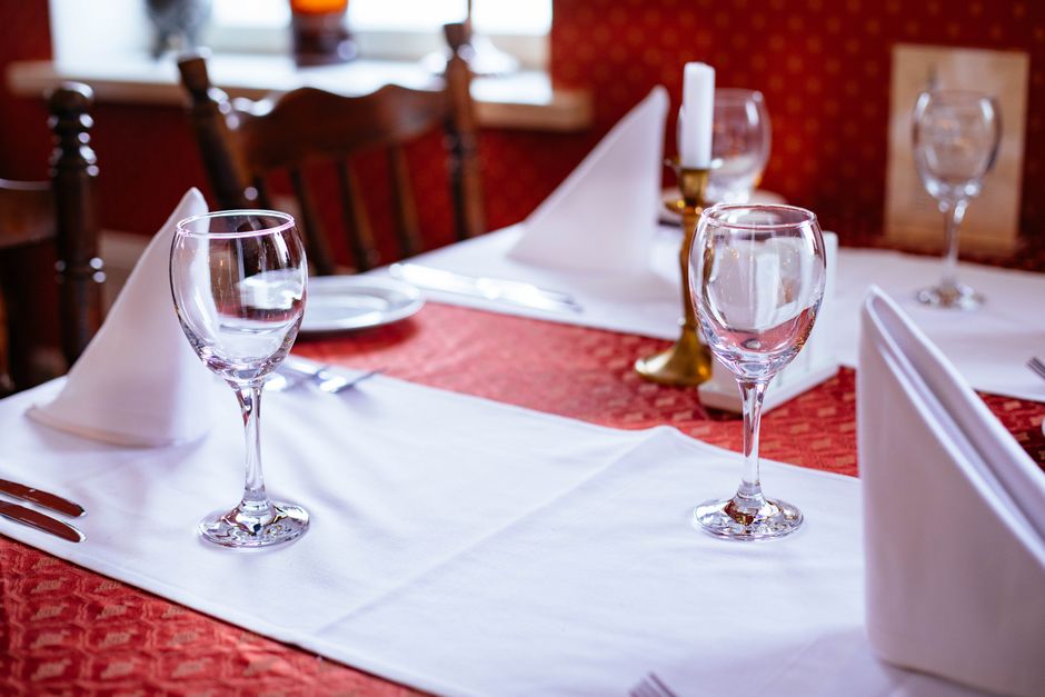 Elegant fine dining table setting with wine glasses and refined tableware