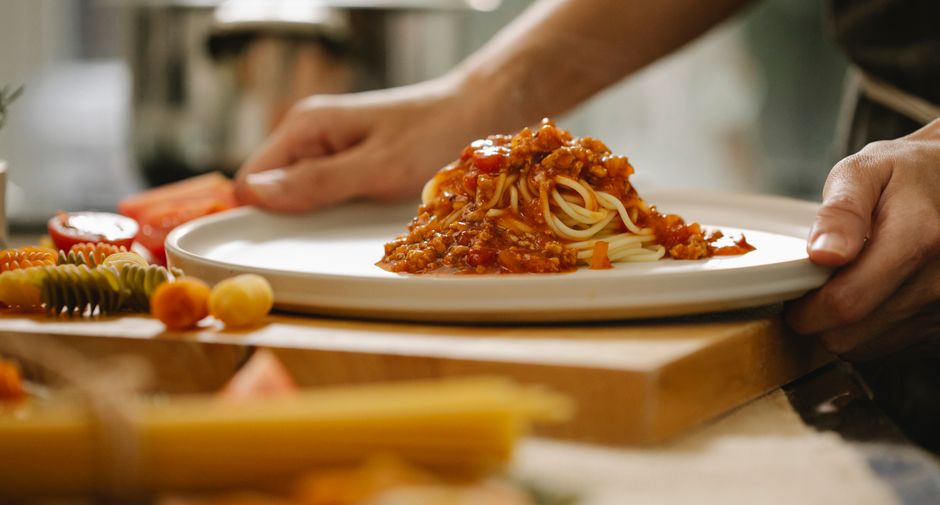 Expert Italian chef crafting fresh handmade pasta in a professional kitchen